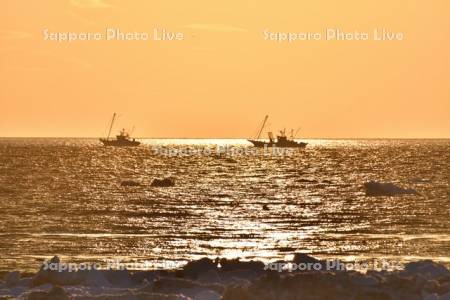 朝焼けとホタテ漁船と流氷